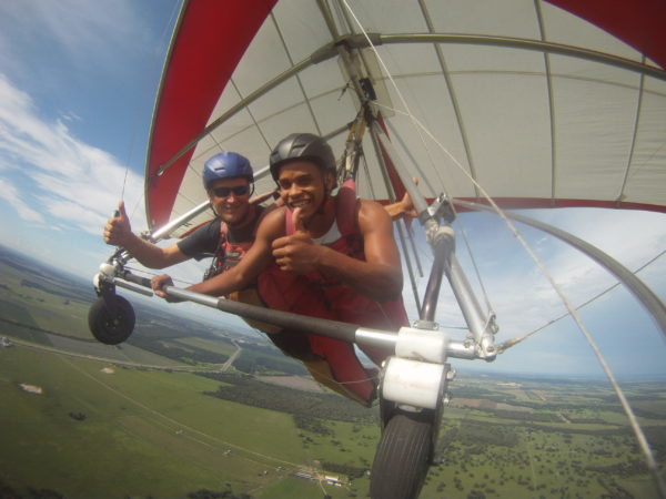 African American man flying tandem in a hang glider