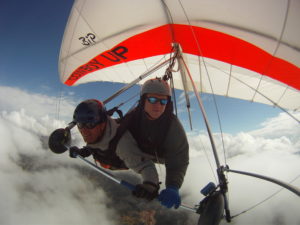 Tandem hang glider above the clouds